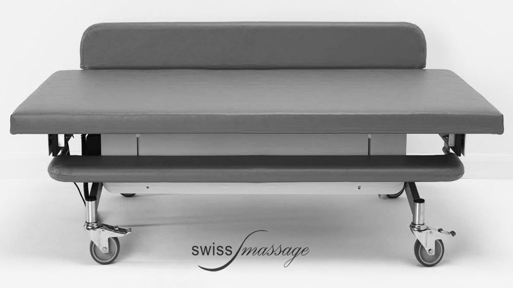 Table médicale de change pour soins médicaux aux personnes souffrant d'un handicap, équipée de barrières de sécurité ici abaissée